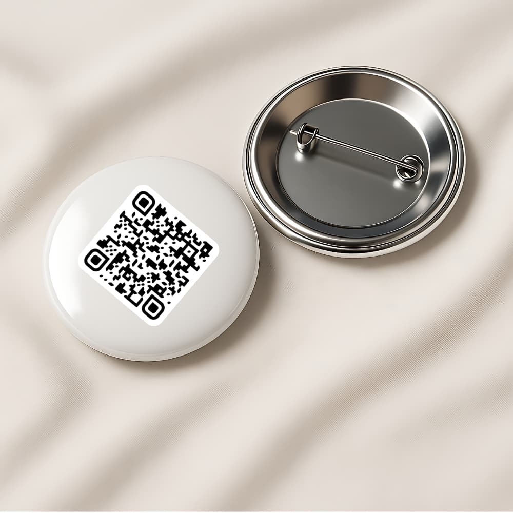 Pin-back button badge printed with a TipMe QR code